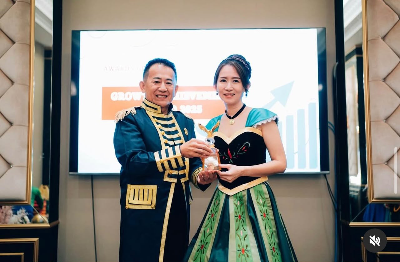Emily Tan receiving an award on stage